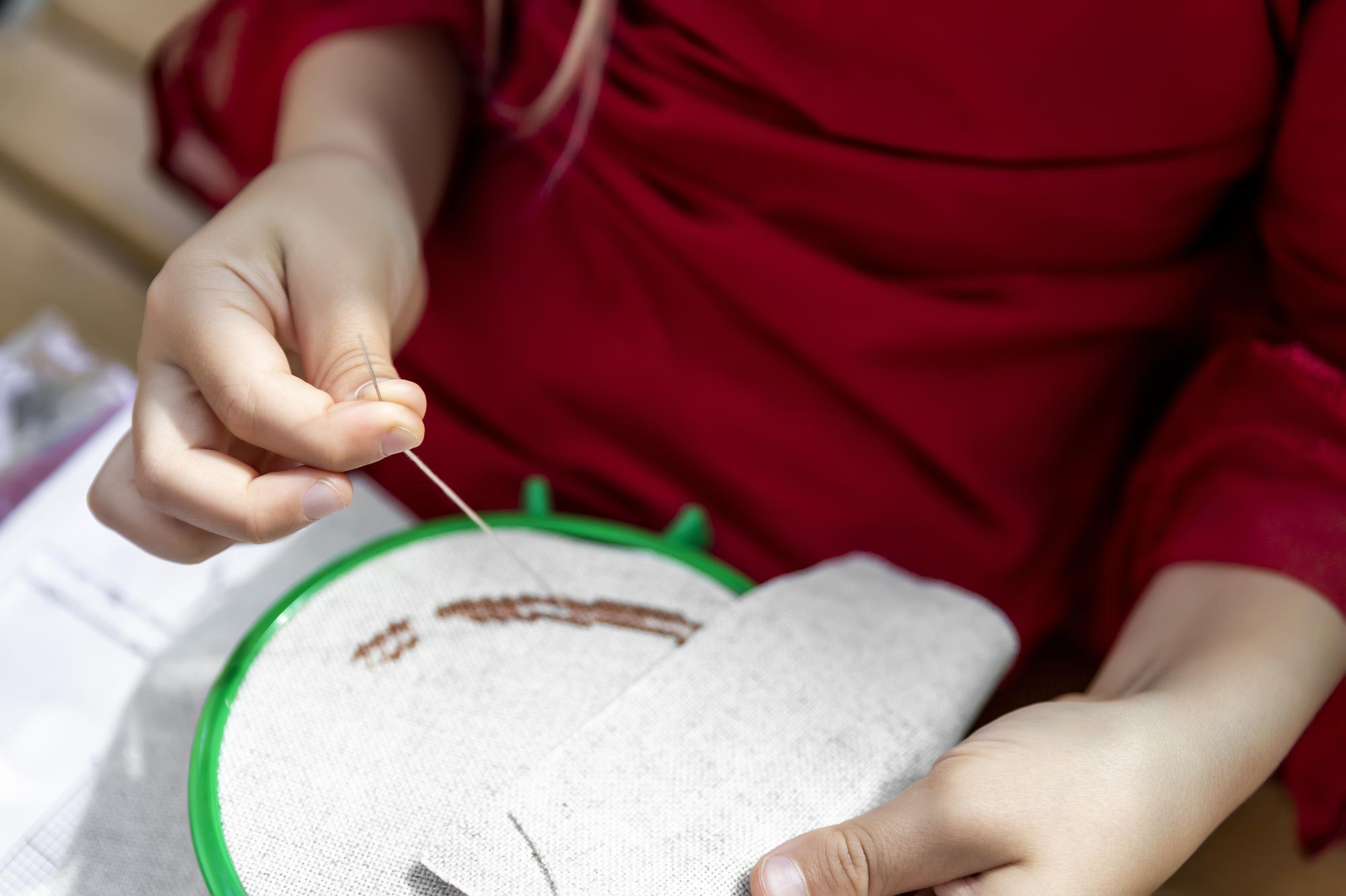 Teacher demonstrating stitch to a small group